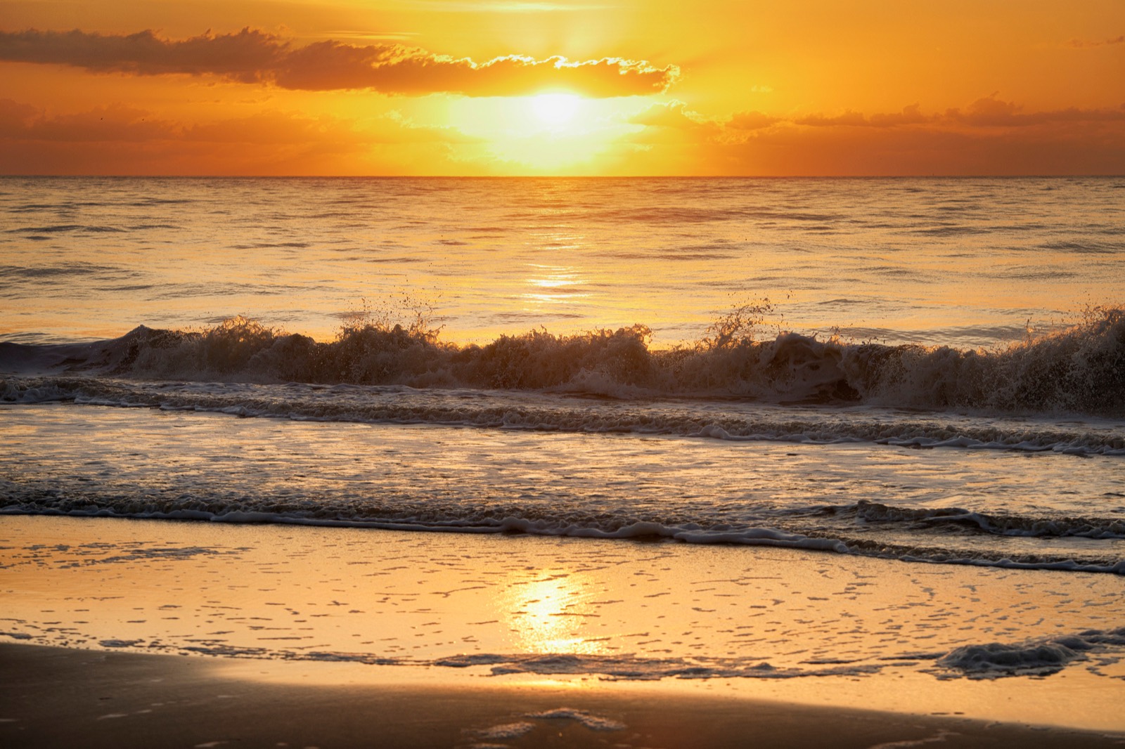 Sunset over the Atlantic with waves on the shore