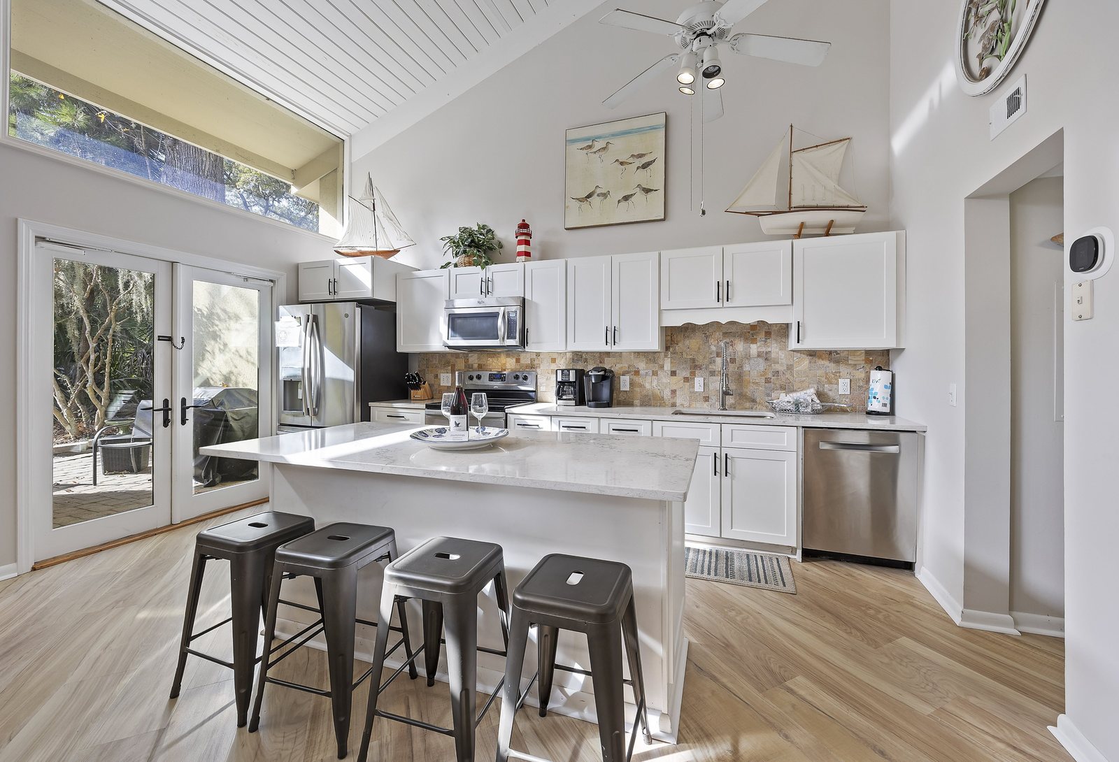 Bright villa kitchen with an island and bar stools